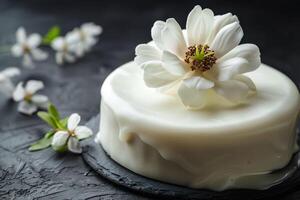 AI generated An exquisite cake featuring smooth white icing and a delicate, realistic sugar magnolia flower. Generative AI. photo