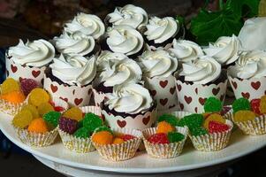 a white plate with cupcakes and candies on it photo