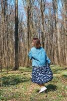 Woman playing with dog in the forest, spring time photo