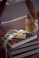 Gift certificate next to  perfect  place for reading and relaxing, a white armchair surrounded by books in a bright room photo