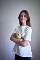 teenage girl with her favorite toy from childhood, a green stuffed turtle photo