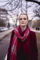 portrait of a stylish middle-aged woman with braids on a spring street photo