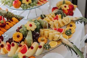 Fruit buffet for a wedding. Assortment of exotic fruits in the restaurant. Various compositions from fresh fruits. photo