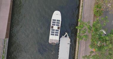 An aerial view of A Solar powered shuttle boat surfing on the canal at central of the city video