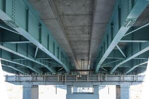 steel frame and concrete construction huge car bridge across the wide river photo