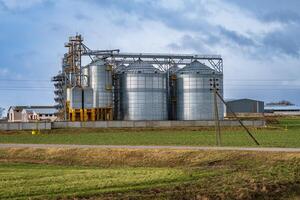 silos on agro-industrial complex with seed cleaning and drying line for grain storage photo