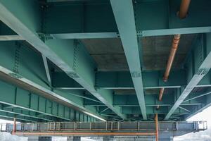 steel frame and concrete construction huge car bridge across the wide river photo