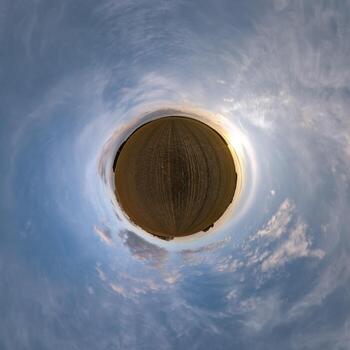 simple green tiny planet without buildings in blue sky with beautiful clouds. Transformation of spherical panorama 360 degrees. Spherical abstract aerial view. Curvature of space. photo