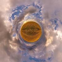 simple tiny planet without buildings in blue sky with beautiful clouds. Transformation of spherical panorama 360 degrees. Spherical abstract aerial view. Curvature of space. photo