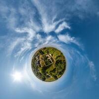 simple tiny planet without buildings in blue sky with beautiful clouds. Transformation of spherical panorama 360 degrees. Spherical abstract aerial view. Curvature of space. photo