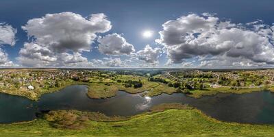 aerial full seamless spherical hdri 360 panorama view over the island and meandering river or lake with beautiful clouds in equirectangular projection, VR content photo