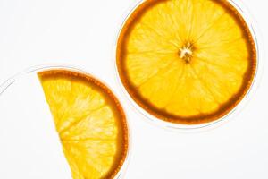 Macro photo of slices of ripe juicy orange with back light isolated on white background. Top view