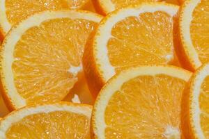 Sliced ripe oranges as a food background. Exotic fruits photo