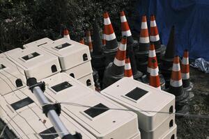 Roadblocks and building materials piled in an open space photo