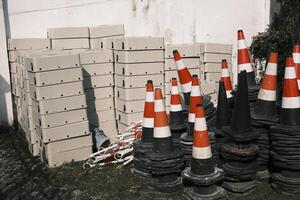 Roadblocks and building materials piled in an open space photo