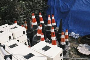 Roadblocks and building materials piled in an open space photo