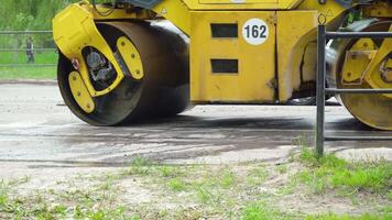 Road roller working on asphalt pavement installation video