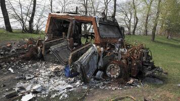 A burnt and destroyed armored car of the Russian army as a result of a battle with Ukrainian troops near Kyiv. Russian aggression in Ukraine. Ukraine is waging a liberation war with Russia. video