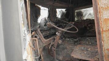 Cabin from the inside of a burnt and destroyed Russian armored military truck for transporting soldiers. The result of the battle between Russian troops and Ukrainian troops near Kyiv. video