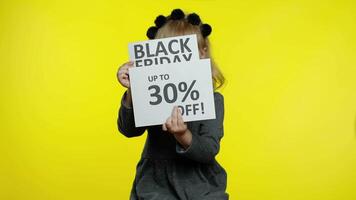 Child girl showing Black Friday and Up To 30 Percent Off advertisement banners. Low prices, shopping video