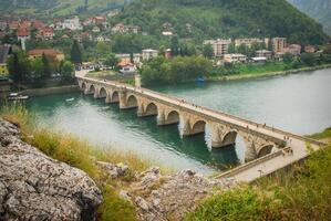 View of Mehmed Pasa Sokolovic Bridge in Visegrad, Bosnia and Herzegovina. Unesco world heritage site. Bridge over the Drina river. photo