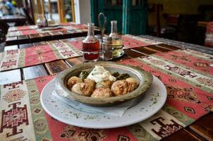 Sogan dolma Bosnian dish. Stuffed onion and wine leaf with meat. photo