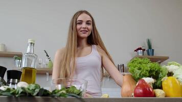 Vegan girl cooking salad with raw vegetables, adding lemon juice. Squeeze a lemon fruit in hands video