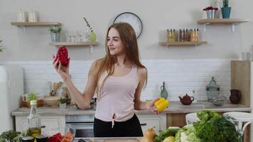 Girl recommending eating raw vegetable food. Showing peppers in hands. Weight loss and diet concept video