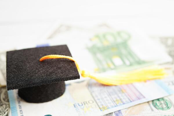 Graduation gap hat on Euro and US dollar banknotes money, Education study fee learning teach concept.