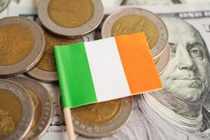 Ireland flag on coin and banknote money, finance trading investment business currency concept. photo