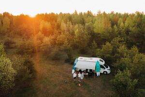 The family is resting at their racetrack, located in the forest at sunset photo