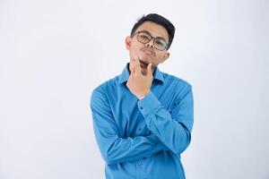 thinking asian businessman with glasses holding a chin wearing blue shirt isolated on white background photo