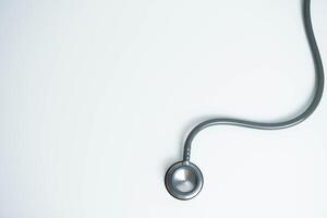 Stethoscope isolated on white background, top view. Medical tool. Health care concept. Copy space photo