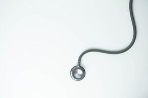 Stethoscope isolated on white background, top view. Medical tool. Health care concept. Copy space photo