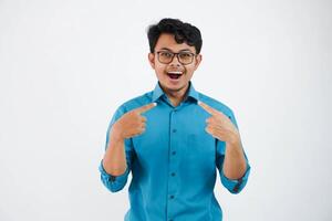 shocked or shouted young asian businessman with glasses Cheerful blue shirt excited point finger at himself open mouth isolated on white background photo