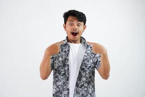 shocked or shouted young asian man Cheerful black shirt excited point finger at himself open mouth isolated on white background photo