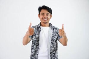 smiling or happy young asian man thumb up finger gesture wearing black shirt isolated on white background photo