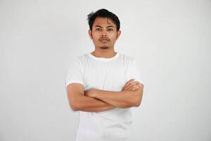 seriously asian man crossed arms and looking camera wearing white t shirt isolated on white background photo