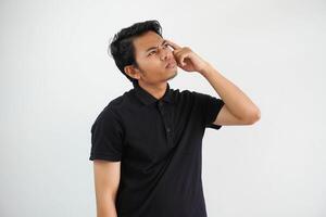 thinking something idea young asian man and hand holding head casual outfit black polo t shirt isolated on white background photo