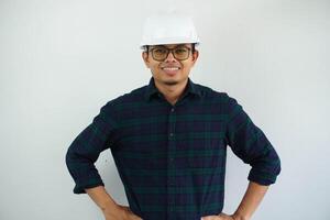 smiling young Asian man engineering showing excited expression with both hand on his waist isolated on white background photo