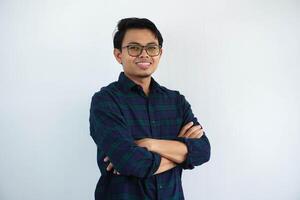 smiling young asian man showing happy expression standing confident with arms crossed isolated on white background photo