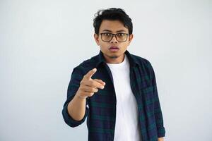 young asian man showing confused face expression with pointing forward isolated on white background photo