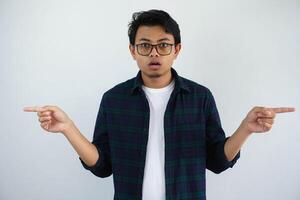 young asian man showing amazed expression while pointing to the left and right side isolated on white background photo