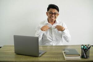 young asian businessman in a workplace with surprise facial expression, wearing white shirt with glasses isolated photo