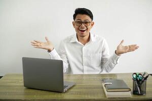 young asian businessman in a workplace shocked facial expression with both hands open, wear white shirt with glasses isolated photo