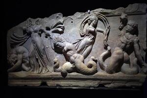 ISTANBUL, TURKEY - JANUARY 7 2024 - Istanbul Archaeological Museum Gigantomachy bas relief war between gods and giants photo