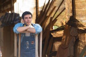 Portrait of carpenter male worker standing in workshop photo