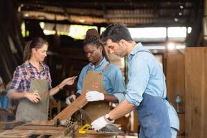 Portrait of carpenter male worker standing with laptop in workshop photo