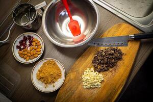 Woman cooking tasty melted chocolate on table in kitchen. photo