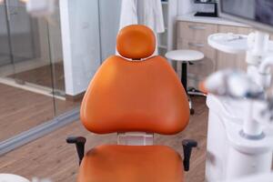 Close up view at set of dentist tools in modern dental office with nobody in it. The interior of stomatology clinic. photo